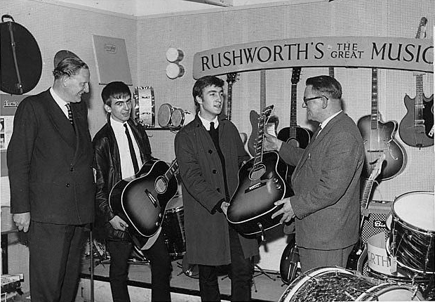 John Lennon and George Harrison receive their Gibson J160e